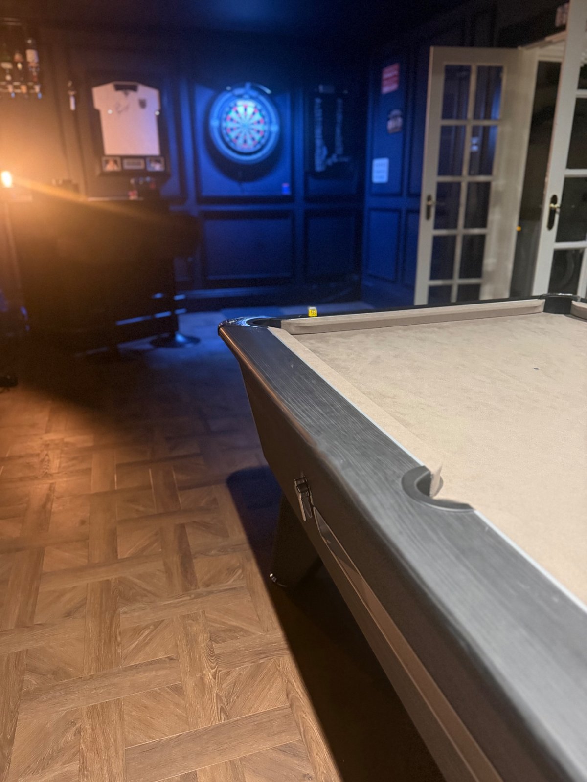 Finished games room from a second angle, panelling and parquet-style floor