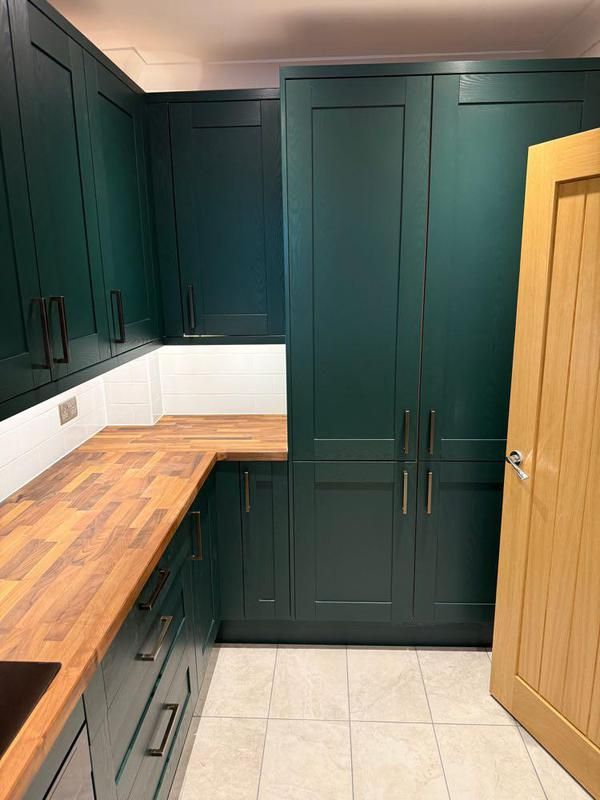 Dark green tall units beside an oak door