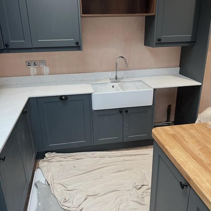 Dark units with a ceramic butler sink and timber worktop