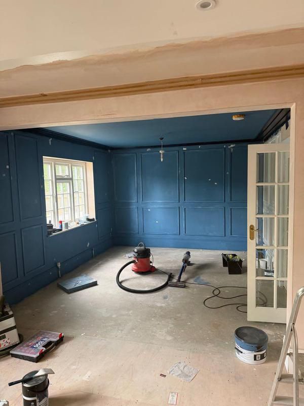 Blue panelled room during the works with tools on the floor