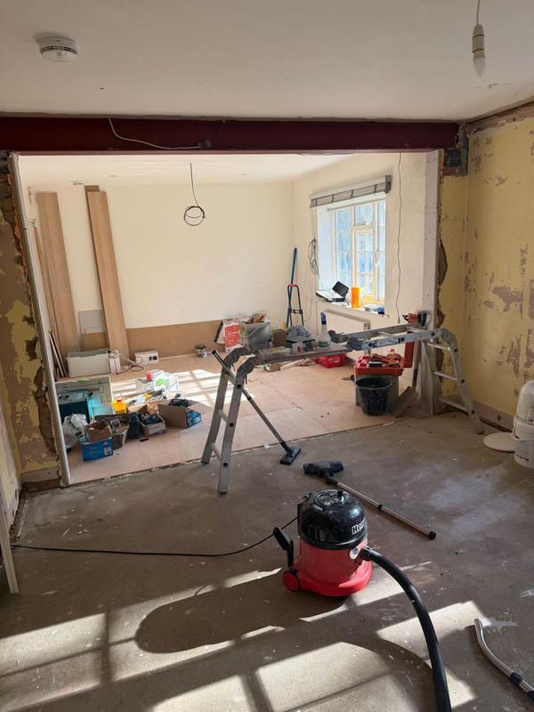 Room opened up during the works with timber stacked on the floor